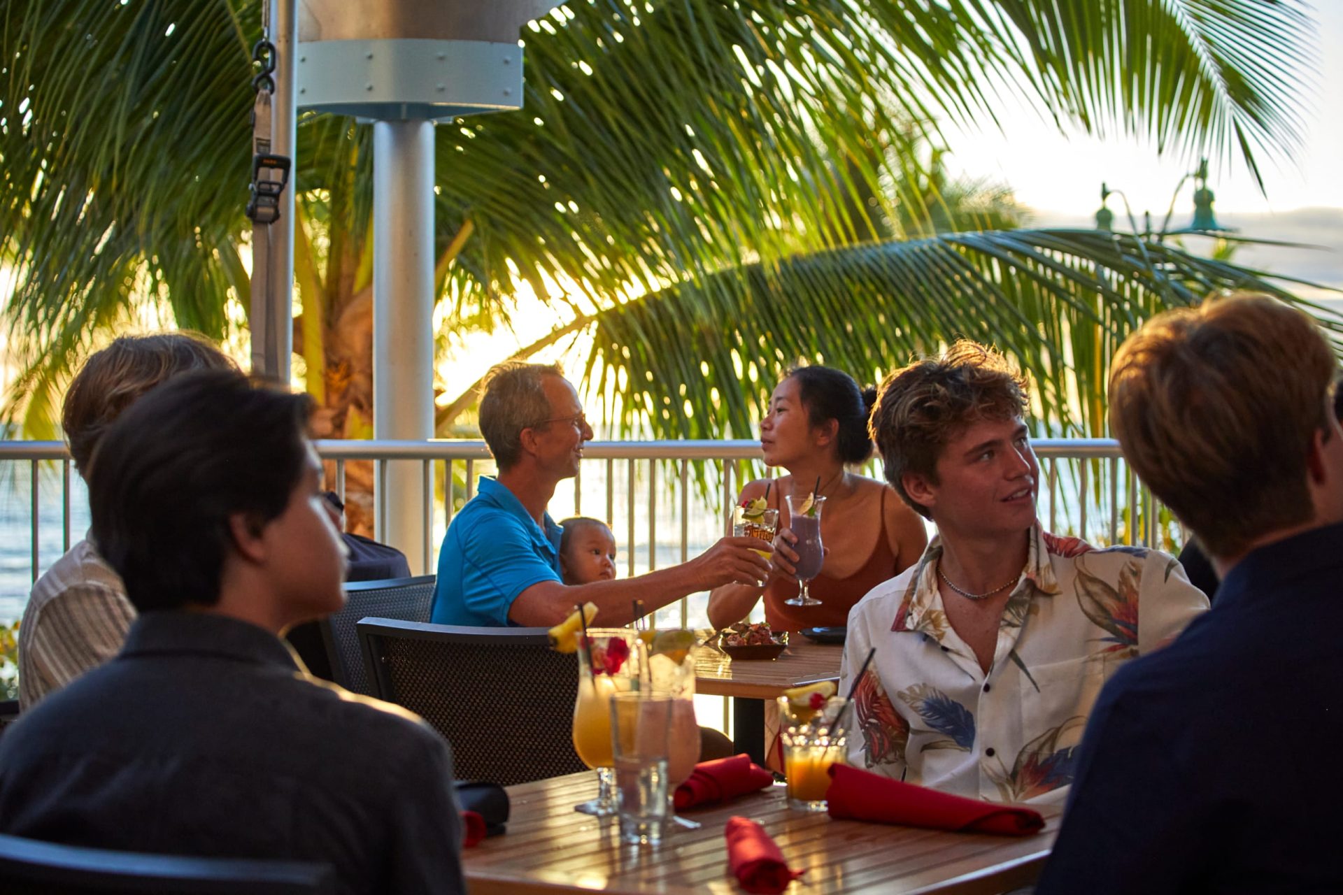 Couple eating food Tiki's golden hour palm trees